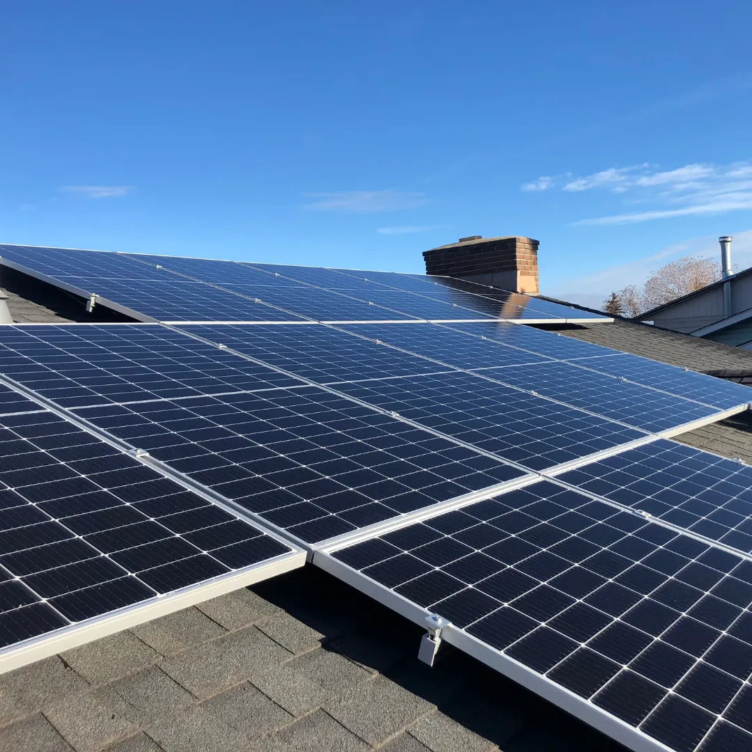 Roof-mounted solar modules on racking, low-angle view
